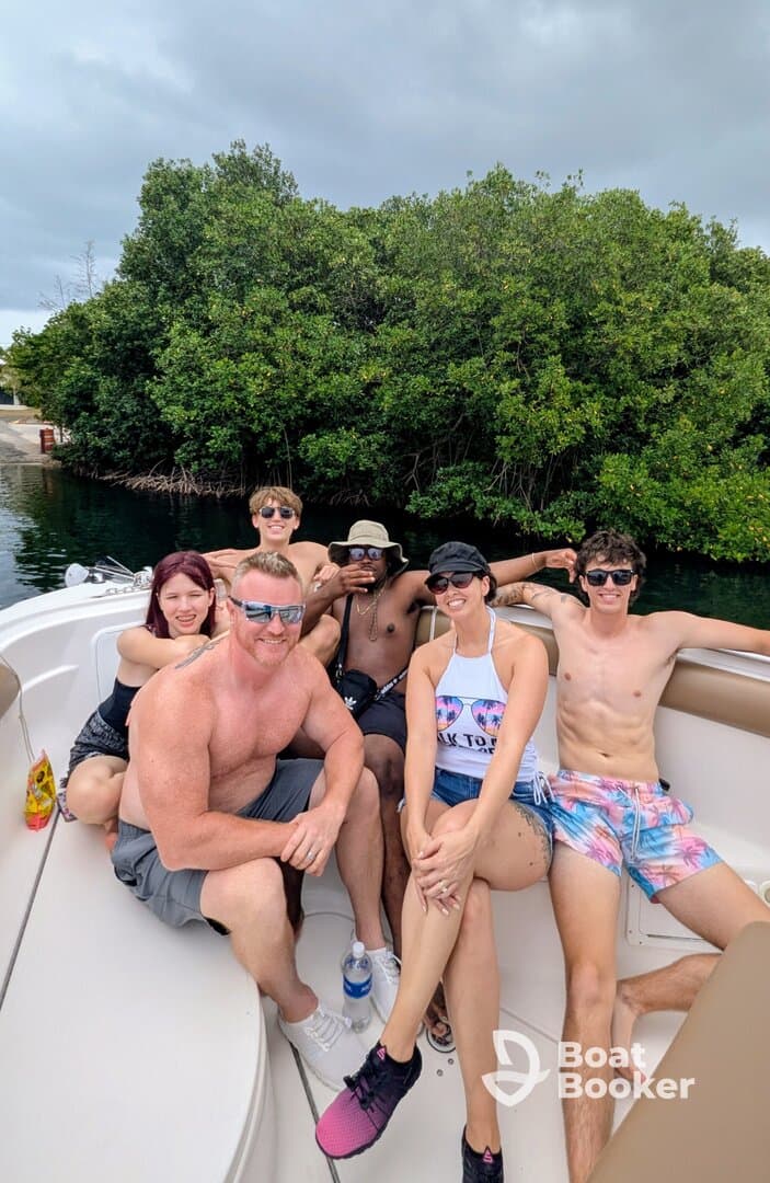 A lively group enjoys a fun day on the boat, surrounded by lush greenery — perfect for memorable outings and celebrations on the water.