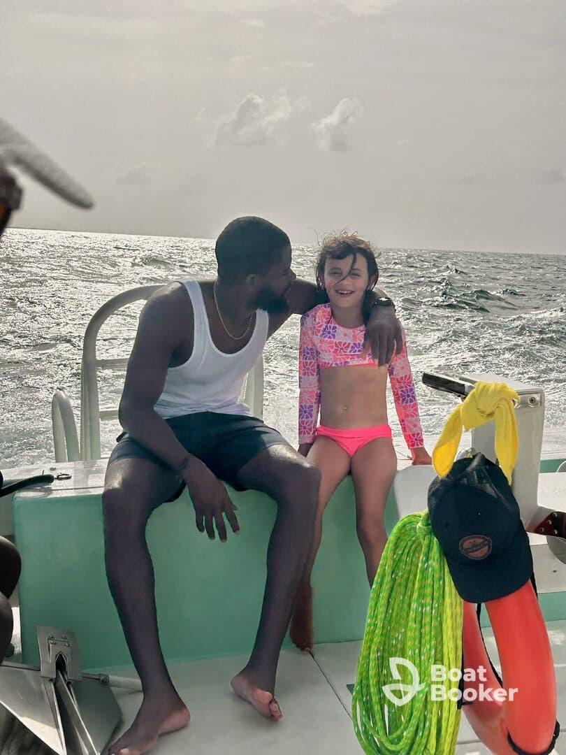 A joyful moment captured on a boat, featuring a smiling child and an adult enjoying their time together on the ocean — perfect for family adventures.