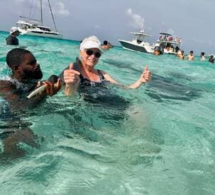 A joyful interaction with stingrays in crystal-clear waters, showcasing a memorable wildlife experience in a tropical paradise.