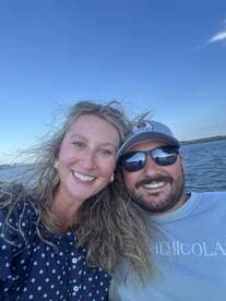 A happy couple enjoys a moment on the water, capturing their joy while boating — perfect for romantic getaways or memorable adventures.