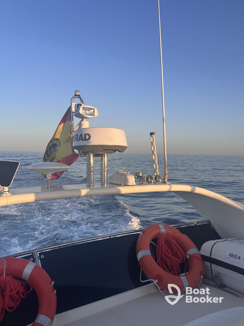 A view of the boat's helm featuring navigation equipment and safety gear, ideal for showcasing the interior setup for a smooth sailing experience.