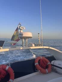 A view of the boat's helm featuring navigation equipment and safety gear, ideal for showcasing the interior setup for a smooth sailing experience.