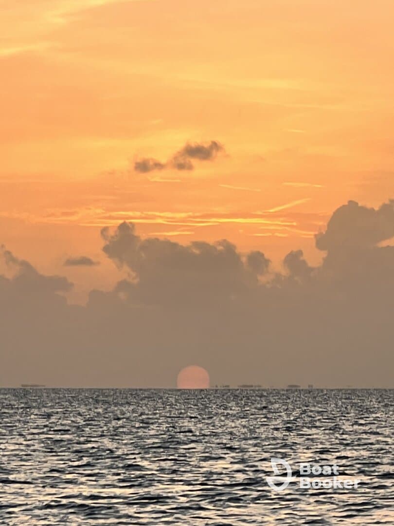 A serene sunset over the ocean, creating a picturesque backdrop for boating adventures. Ideal for sunset cruises and tranquil moments on the water.