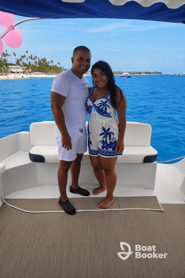 A happy couple poses on the deck of a boat, enjoying a beautiful day on the water — perfect for romantic getaways or special celebrations.