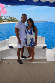 A happy couple poses on the deck of a boat, enjoying a beautiful day on the water — perfect for romantic getaways or special celebrations.