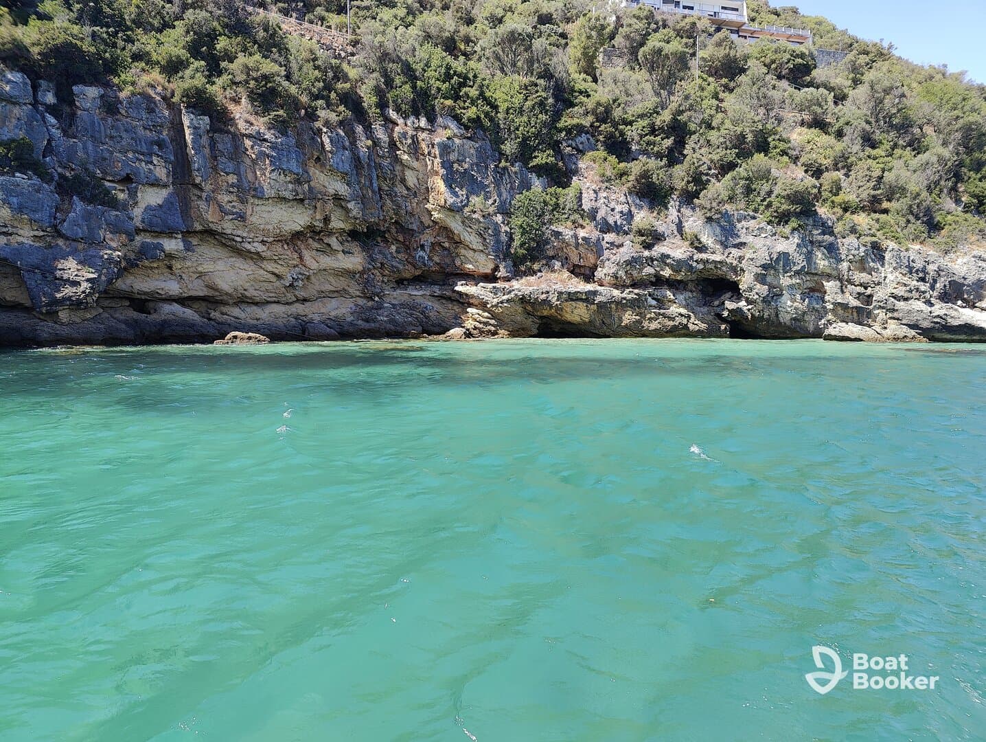 A stunning view of a rocky coastline with clear turquoise waters, perfect for exploring the natural beauty of the area.