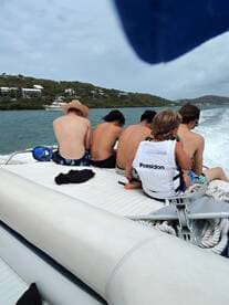 A group of kids enjoying a boat ride, capturing the essence of fun and adventure on the water. Perfect for family outings and youth excursions.