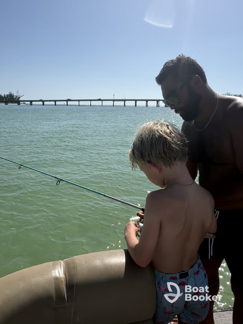 A father and son enjoy a fishing experience together, creating lasting memories on the water. Perfect for family bonding and outdoor adventures.
