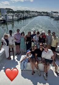 A lively group of friends gathers on a boat, celebrating together with drinks and smiles — perfect for memorable outings and gatherings on the water.