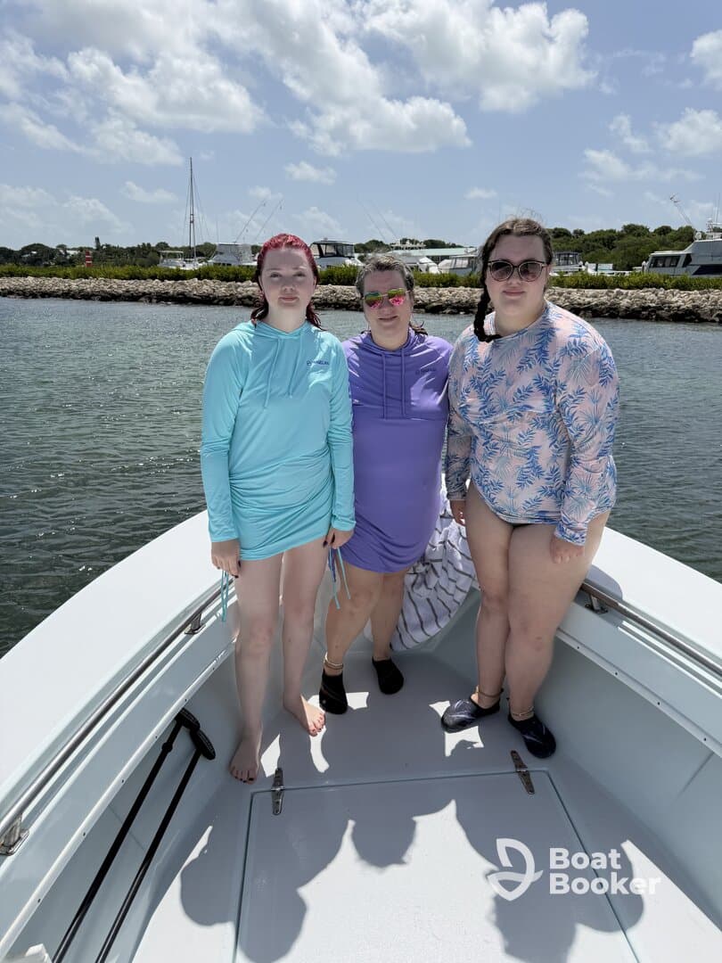 Three friends enjoy a sunny day on the boat, showcasing a fun and vibrant atmosphere perfect for summer outings.
