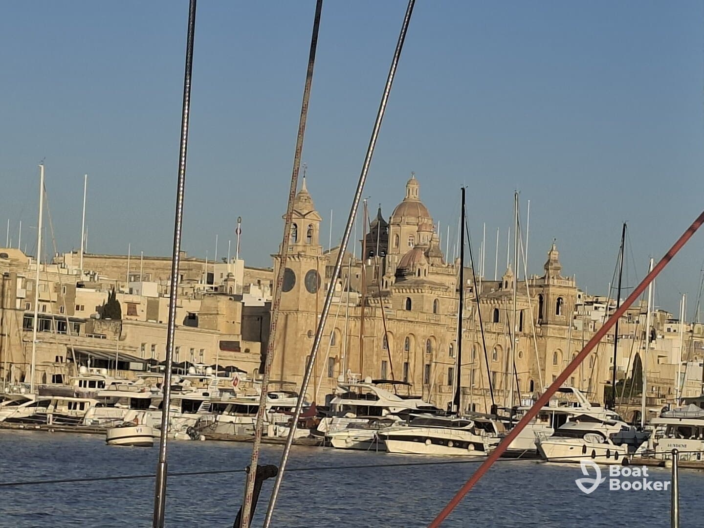 A picturesque view of a harbor filled with boats, showcasing stunning architecture in the background — a perfect destination for maritime enthusiasts.