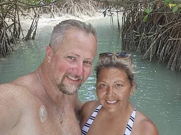 A couple enjoys a moment together in a serene mangrove setting, perfect for capturing memories during their aquatic adventure.