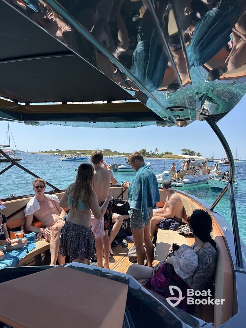 A lively group enjoys a day on the boat, soaking up the sun and having fun in the water — perfect for summer outings and boat parties.