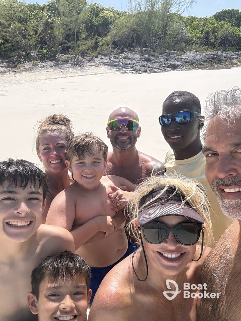 A joyful family poses for a selfie on the beach, capturing a memorable moment of fun and togetherness during their tropical getaway.