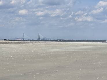 A distant view of a bridge and shoreline, with unclear details and no identifiable subjects.