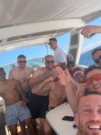 A lively group of friends enjoys a fun day on the boat, celebrating with drinks and laughter under the sun — the perfect backdrop for unforgettable memories.