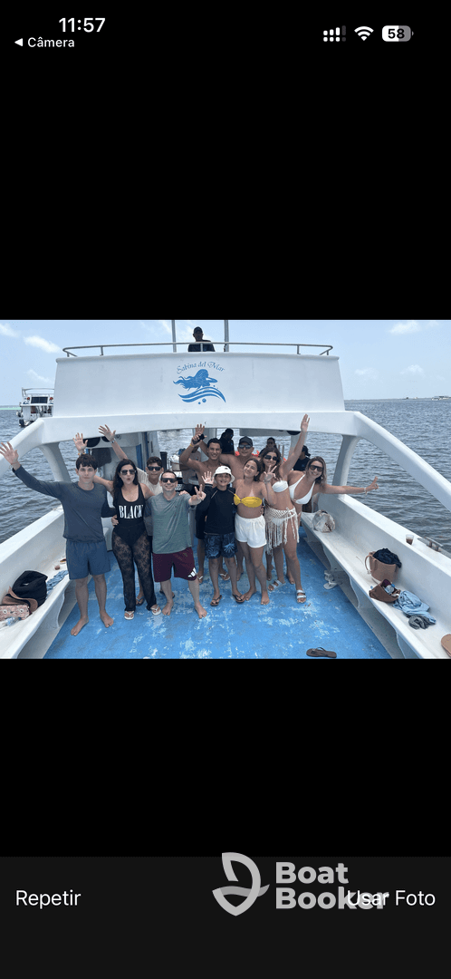 A lively group of friends poses on the deck of a boat, celebrating together in a fun-filled outing on the water.