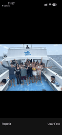A lively group of friends poses on the deck of a boat, celebrating together in a fun-filled outing on the water.