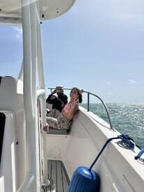Two friends enjoy a sunny day on a boat, capturing the joy of their adventure on the water.