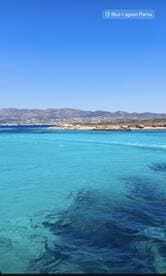 A stunning view of the Blue Lagoon in Paros, showcasing crystal-clear waters and a picturesque coastline — an ideal destination for boat trips and relaxation.