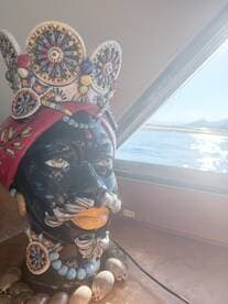 A decorative sculpture adds a unique touch to the interior of the boat, showcasing artistic flair against a backdrop of serene waters.