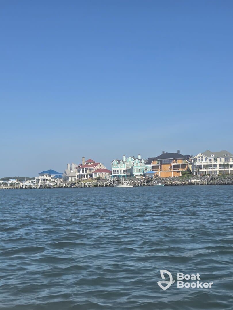 A view of waterfront homes against a clear blue sky, showcasing the scenic coastal architecture.