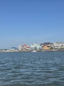 A view of waterfront homes against a clear blue sky, showcasing the scenic coastal architecture.