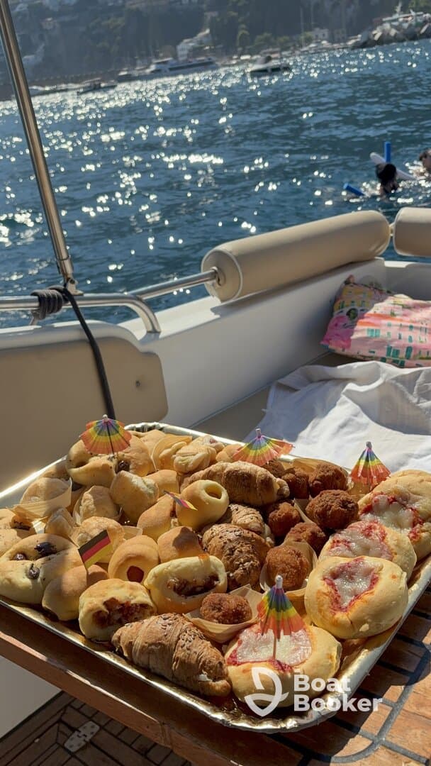 A beautifully arranged platter of snacks on a boat, perfect for enjoying while cruising on the water. Ideal for catering during a day out at sea.