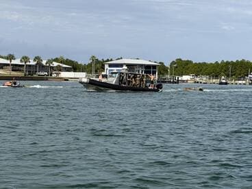 A thrilling scene on the water featuring a jet ski and a boat, showcasing the excitement of on-water activities. Perfect for adventure seekers looking to enjoy a day out on the waves.