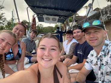 A cheerful group of friends and family enjoy a moment aboard a boat, capturing their fun experience together. Perfect for showcasing memorable boating adventures.