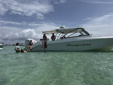 A lively group enjoys a day on the water with the 'Champagne Sprint' boat, swimming and having fun in the clear turquoise waters.