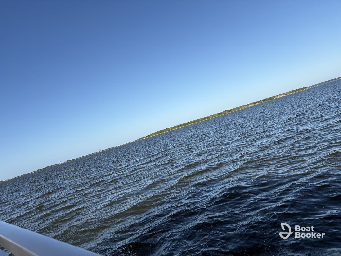 An unclear image of water and a distant shoreline, lacking focus and identifiable subjects.