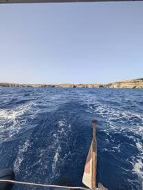 A stunning view of the ocean and coastline from a boat, capturing the essence of a perfect day on the water.