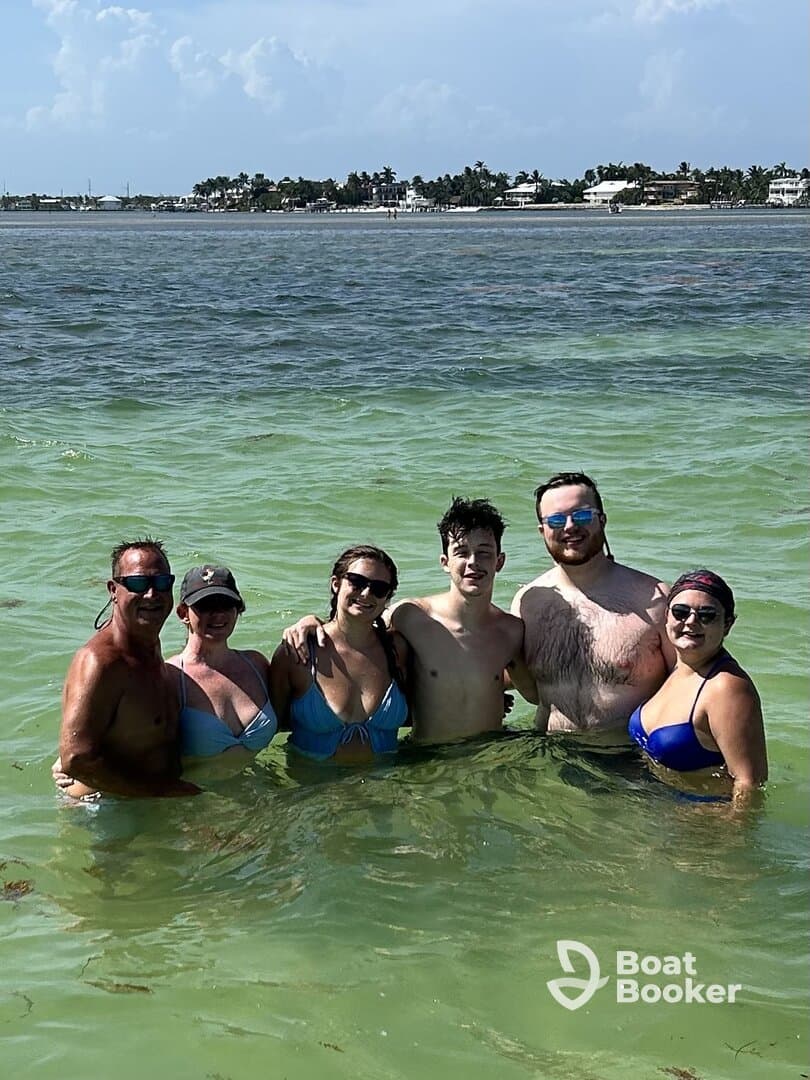 A cheerful group enjoys a refreshing swim in the clear waters, perfect for family outings or beach adventures.