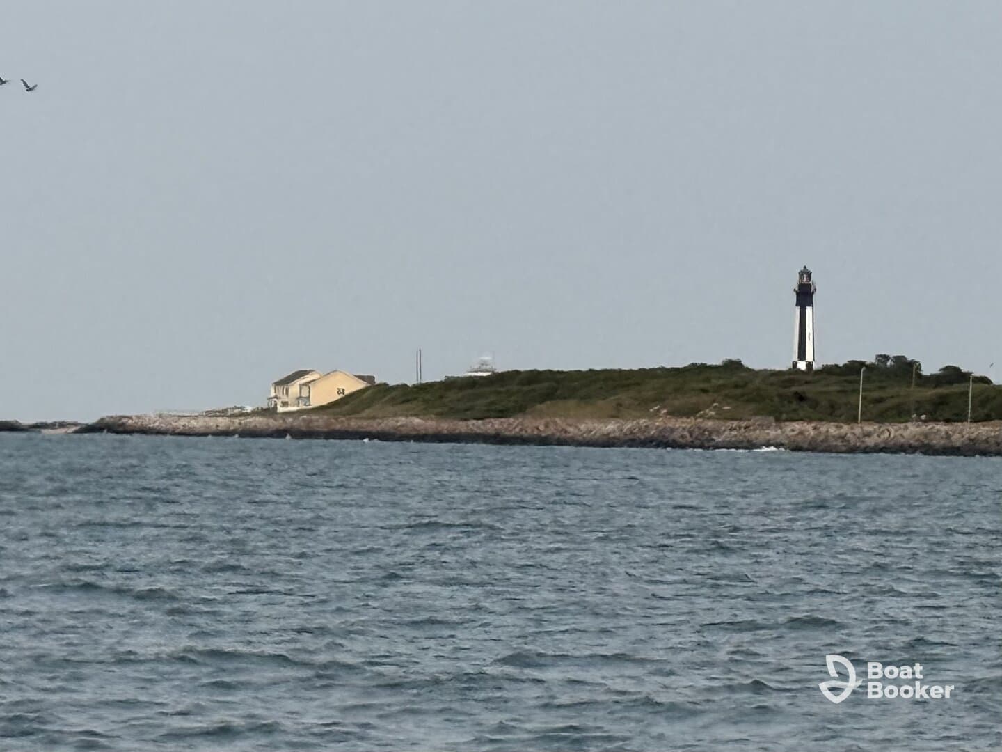 A scenic view featuring a lighthouse and a coastal house, perfect for capturing the beauty of maritime landmarks.