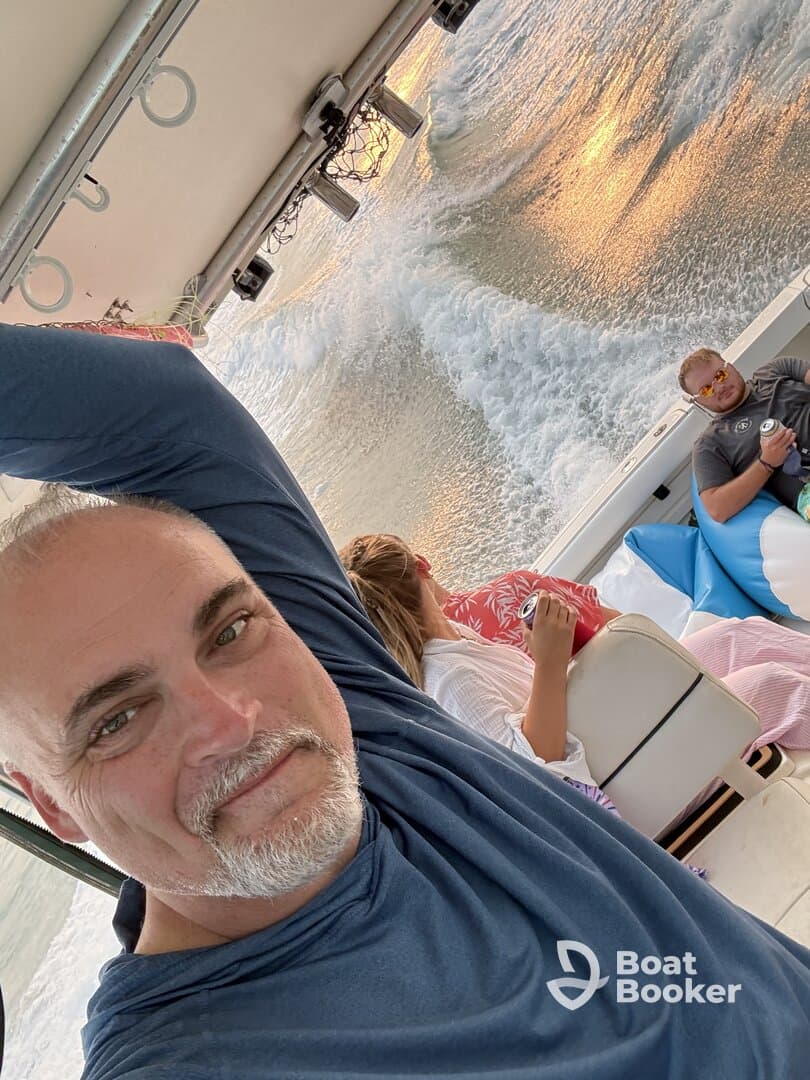 A group enjoys a relaxing moment on a boat, sipping drinks as the sun sets over the water — perfect for memorable outings and celebrations.
