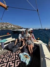 A cheerful group enjoys a relaxing day on a boat, surrounded by stunning views and clear waters — perfect for social gatherings and summer fun.