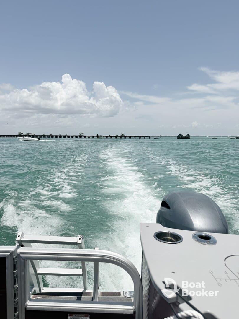 A sleek speedboat cuts through the turquoise waters, showcasing the vibrant marine environment and the excitement of a day on the water.