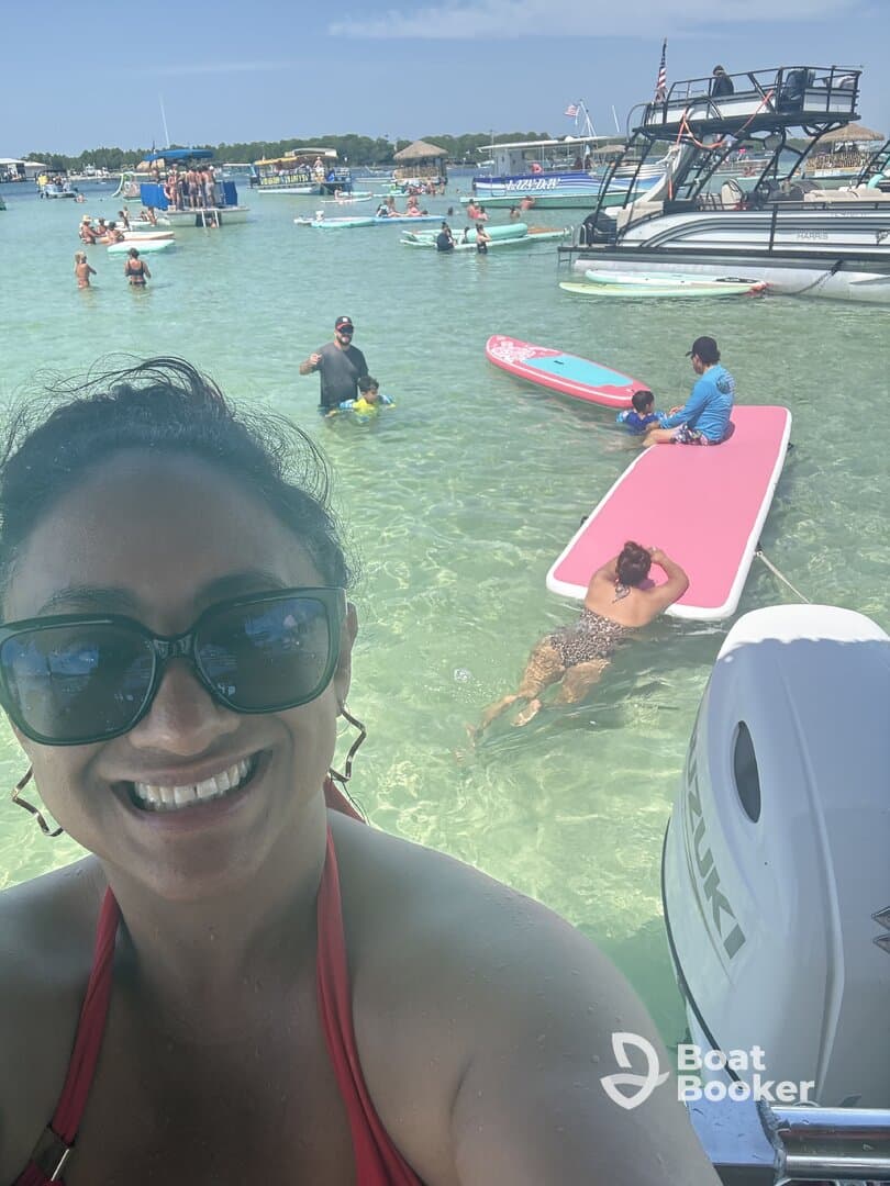 A vibrant scene at a beach with friends enjoying paddleboarding and swimming in clear waters — perfect for a fun day out on the water.