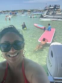 A vibrant scene at a beach with friends enjoying paddleboarding and swimming in clear waters — perfect for a fun day out on the water.