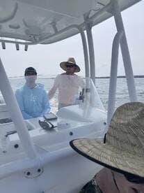 Two men enjoy a day on the water, showcasing the camaraderie and fun of boating adventures.