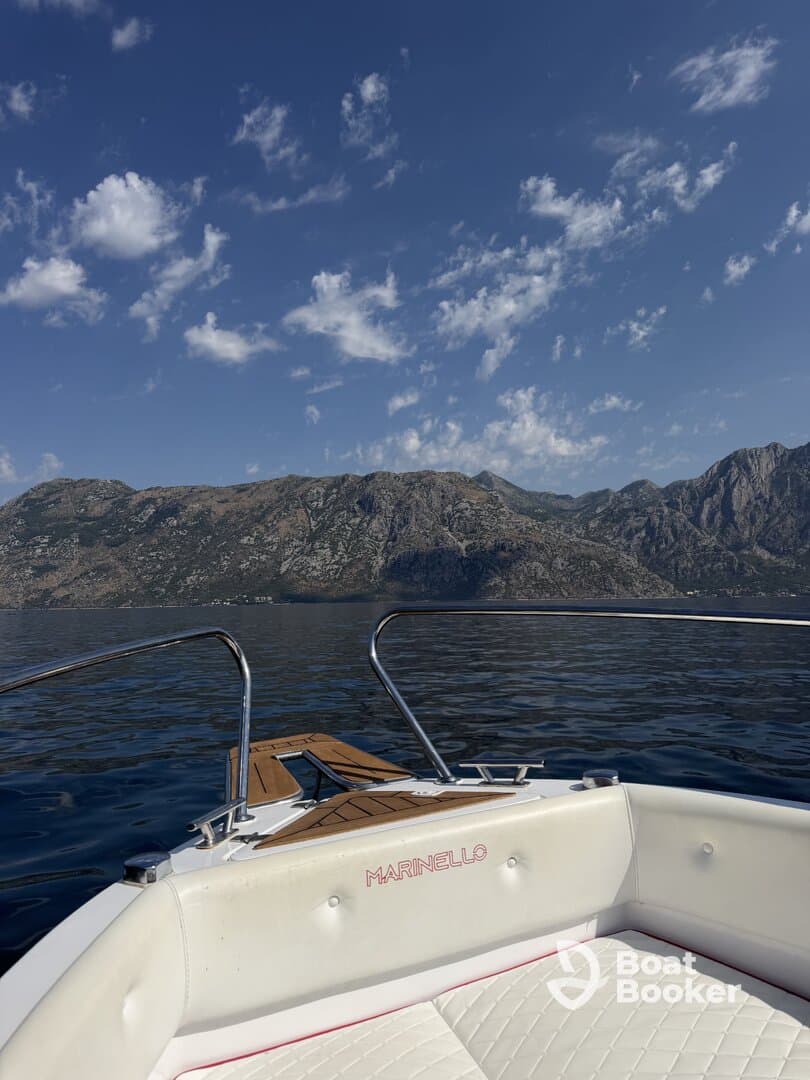A stunning view from the front of a Marinello boat, showcasing the serene waters and mountainous backdrop — perfect for exploring coastal landscapes.