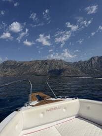 A stunning view from the front of a Marinello boat, showcasing the serene waters and mountainous backdrop — perfect for exploring coastal landscapes.