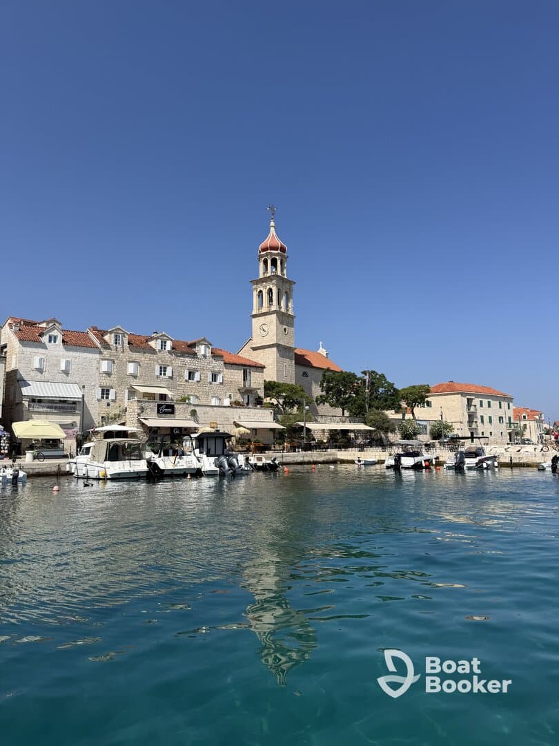 A picturesque view of a charming harbor with historic architecture and boats docked along the waterfront, perfect for exploring coastal destinations.
