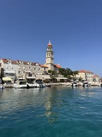 A picturesque view of a charming harbor with historic architecture and boats docked along the waterfront, perfect for exploring coastal destinations.