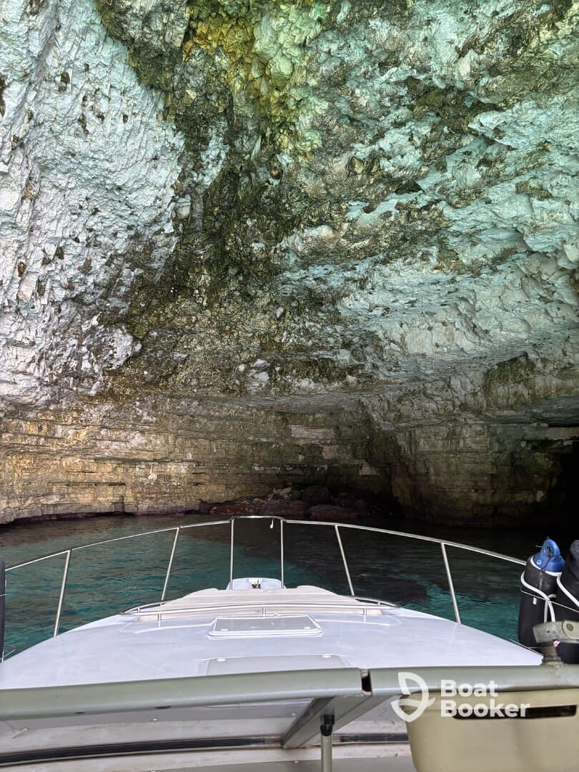 A view from the bow of a boat approaching a stunning cave entrance, showcasing the beautiful rock formations and clear waters — perfect for exploring hidden gems on the water.