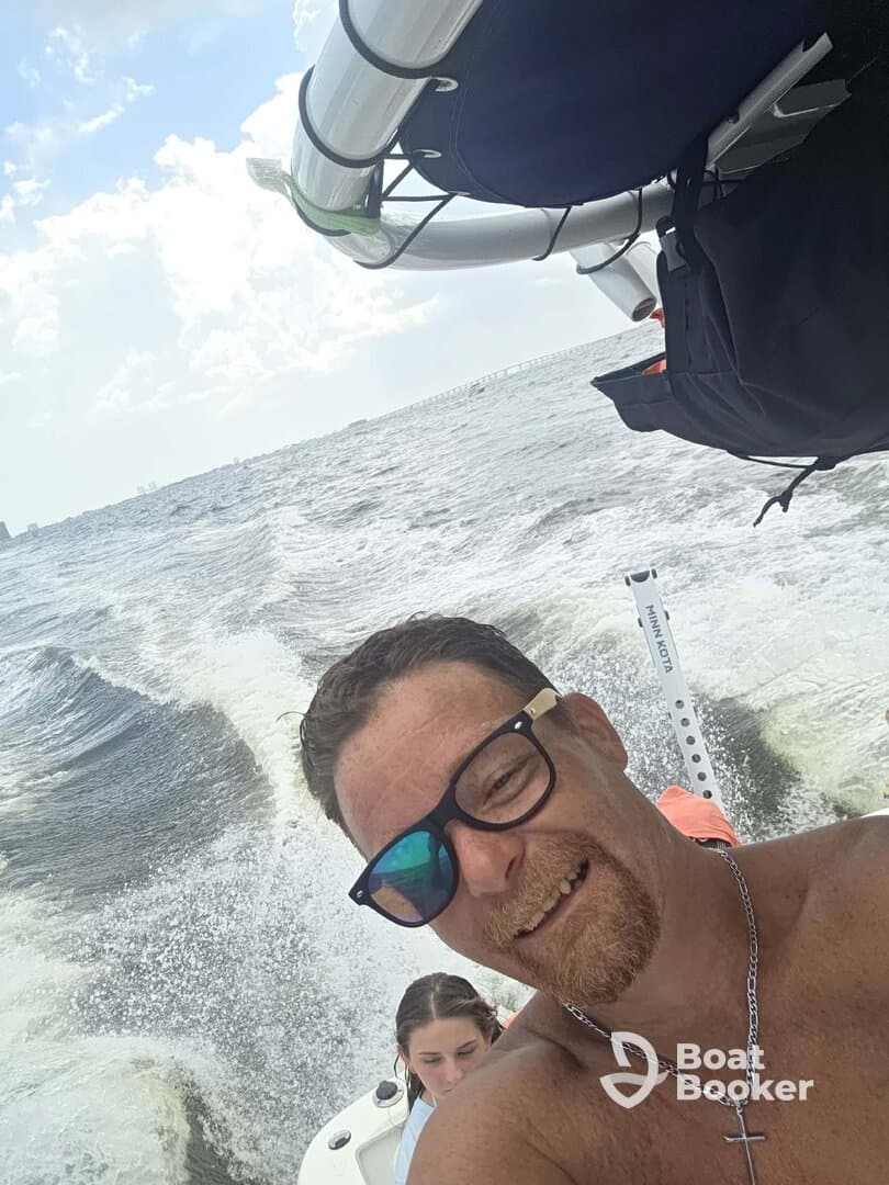 A joyful selfie captures two friends enjoying a day on the water, showcasing the fun and excitement of boating adventures.