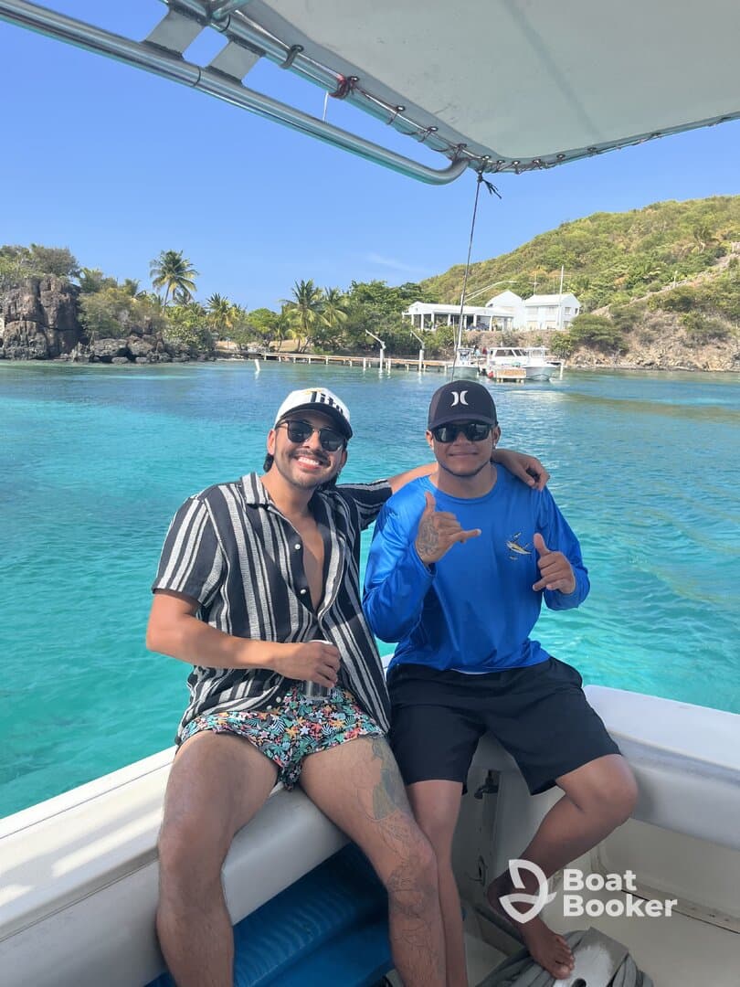 Two friends enjoy a sunny day on a boat, showcasing the perfect atmosphere for fun and relaxation in beautiful waters.