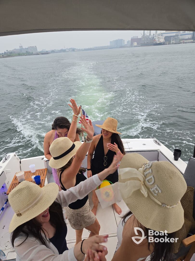 A lively group of friends celebrates on a boat, enjoying a fun-filled day on the water. Perfect for bachelorette parties or summer outings.