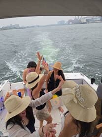 A lively group of friends celebrates on a boat, enjoying a fun-filled day on the water. Perfect for bachelorette parties or summer outings.